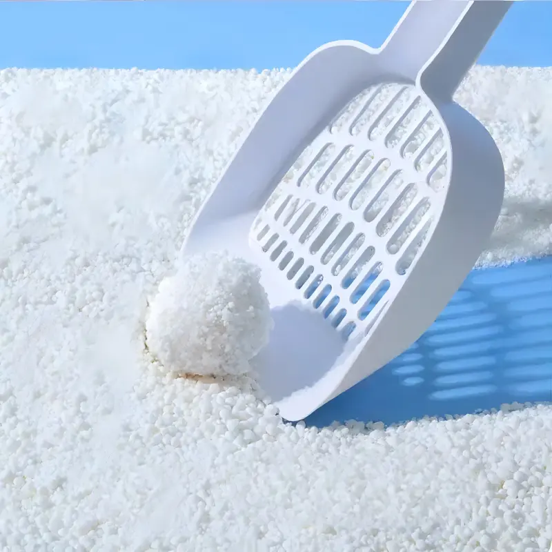 CassavaCrisp™ Cassava Cat Litter — natural white granules with scoop showing excellent clumping performance