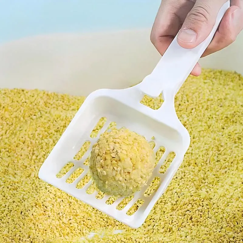 Crushed cat litter showing fast clumping — scoop lifts clean solid clump from litter box